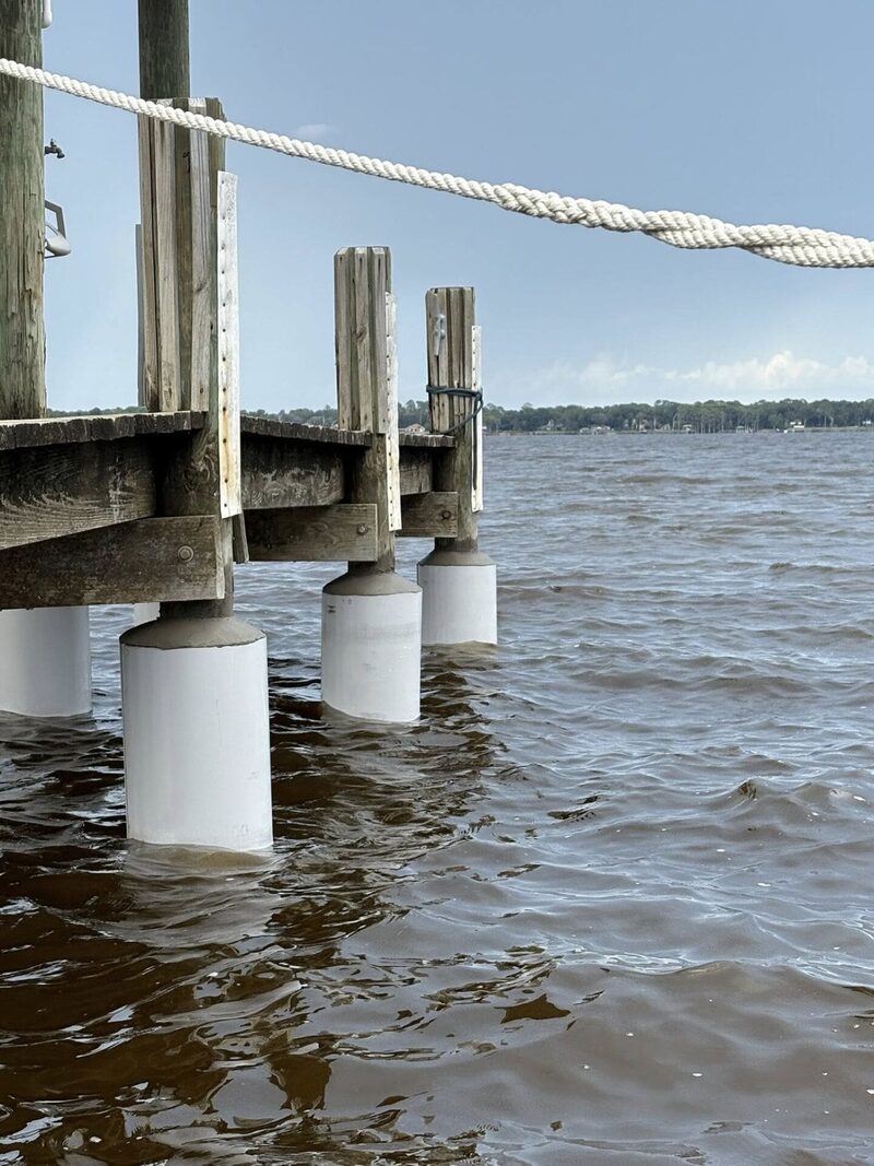 Pilings reinforced at the waterline